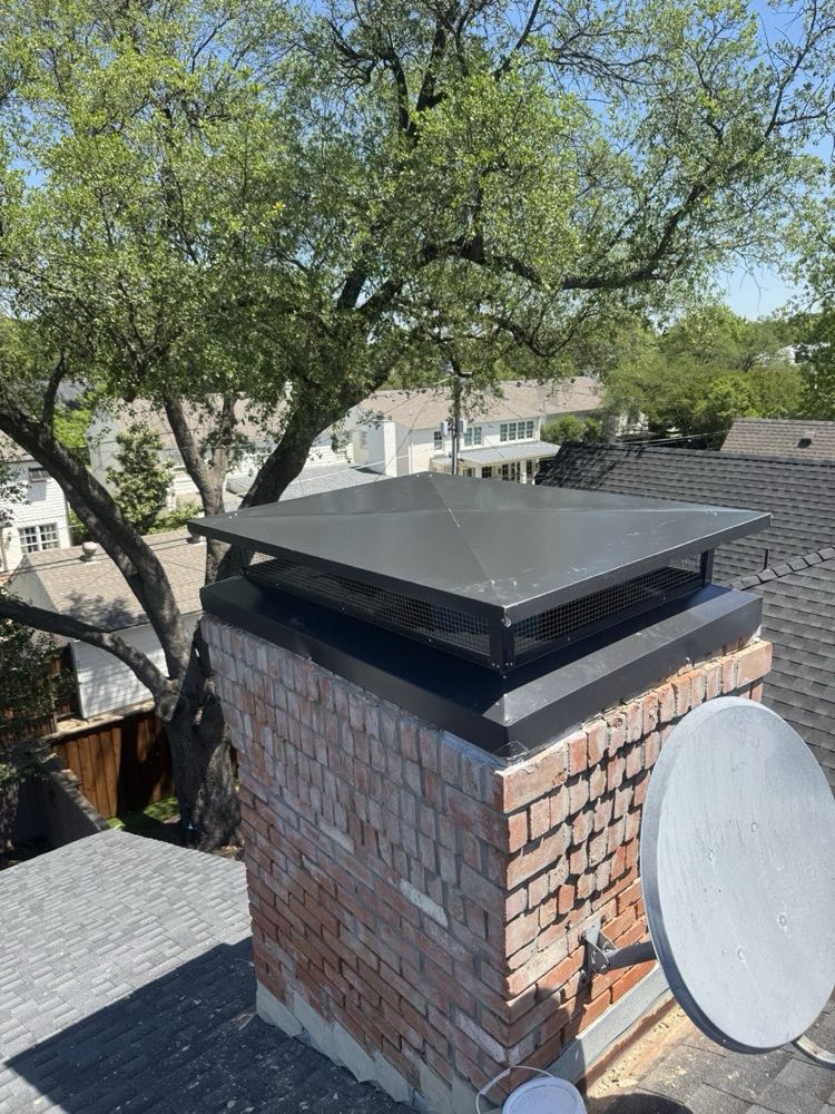 New chimney cap installation on a white brick chimney in North Texas