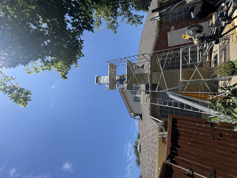 Crew rebuilding a chimney from scaffolding on a Dallas–Fort Worth home