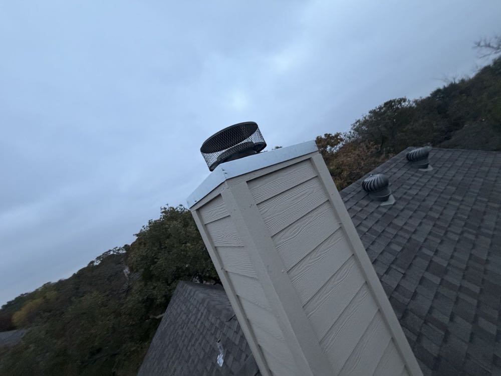 North Texas chimney under storm clouds — sealed flashing keeps wind-driven rain out