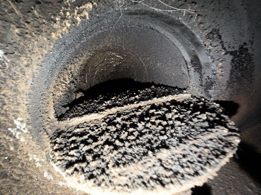 Heavy black creosote buildup inside a chimney flue — the leading cause of chimney fires