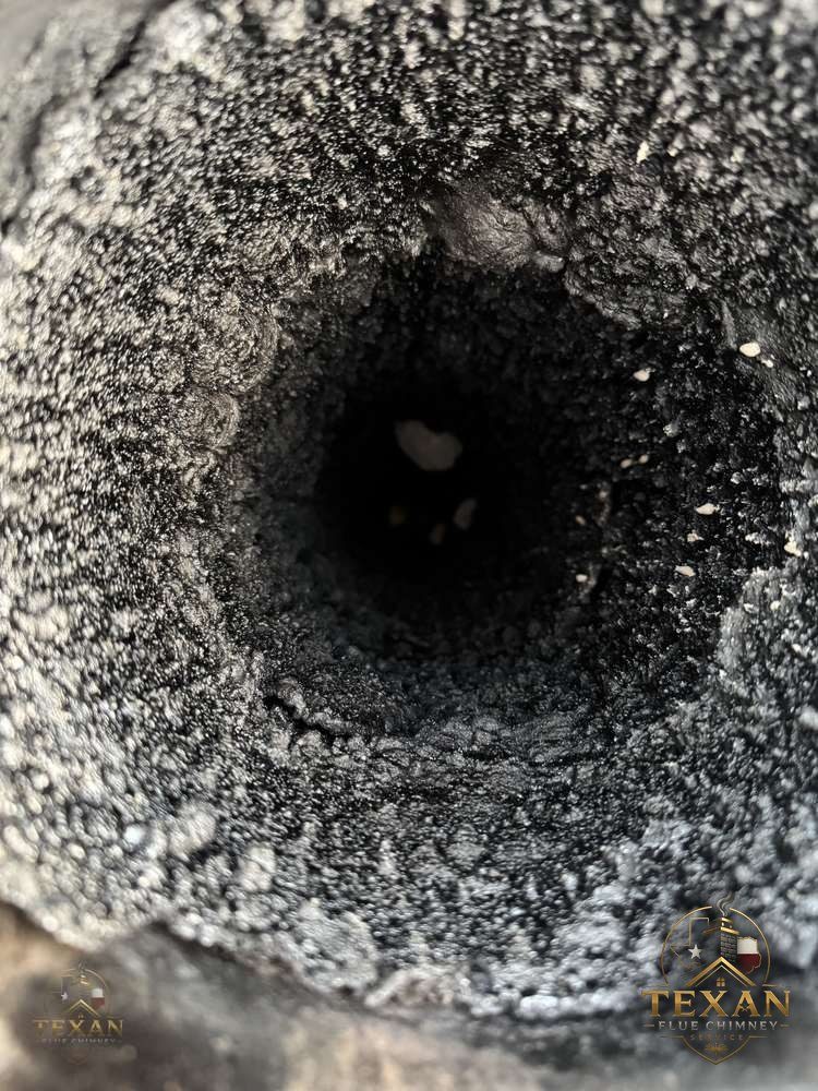 Creosote-lined chimney flue before sweeping — DFW