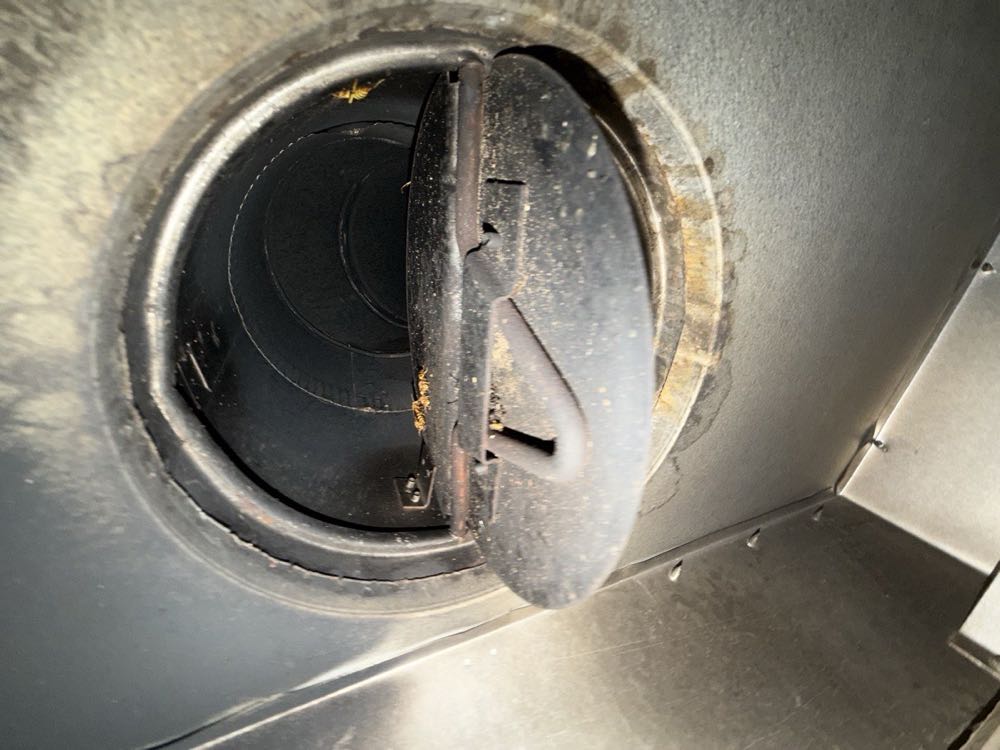 Rusted, soot-caked chimney damper assembly before repair in Dallas–Fort Worth