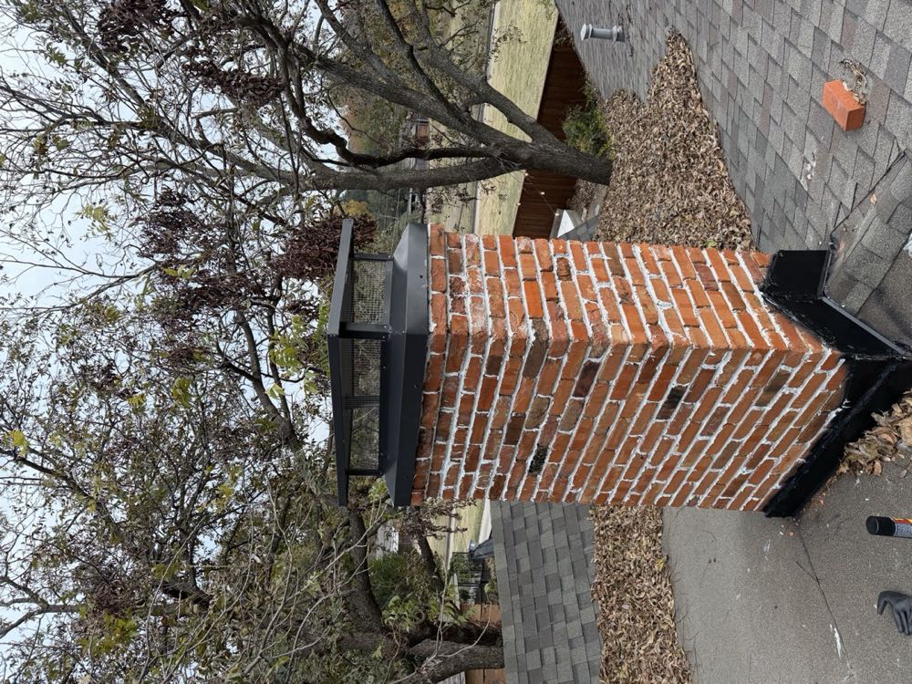 Custom black chimney chase cover installed on a red brick chimney by Texan Flue in Dallas–Fort Worth