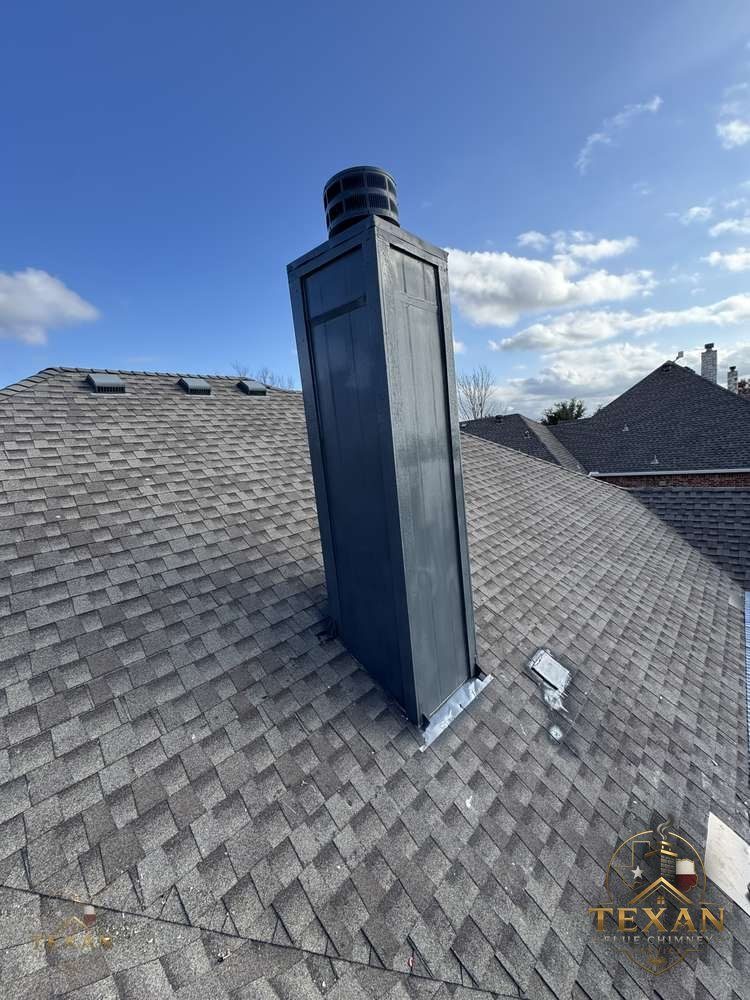 A framed chimney chase with metal chase cover on a two-story master-planned home in Allen, Texas