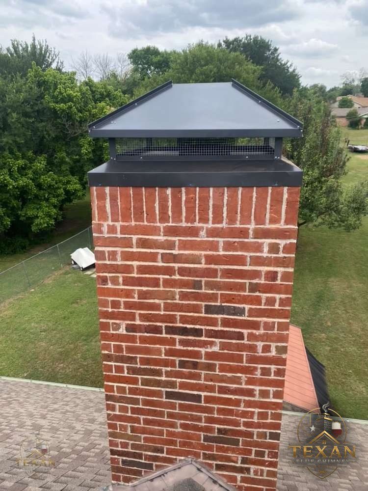 Stately brick-and-stone chimney rising above a well-kept Keller, Texas family home