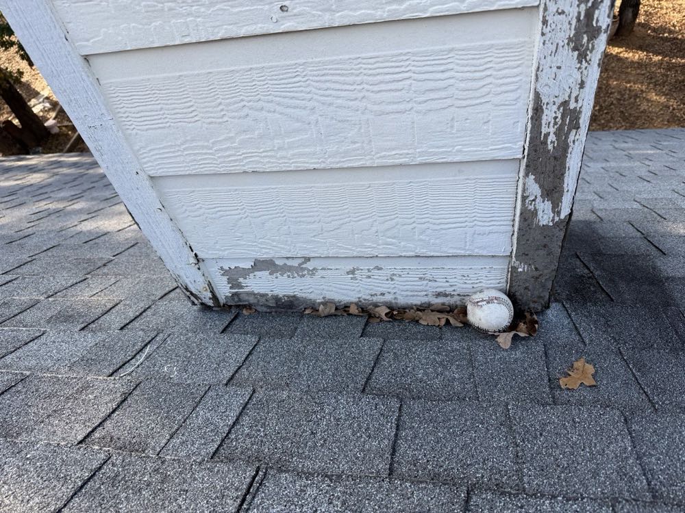 Rotted wood chimney chase with peeling paint before chase cover replacement in North Texas