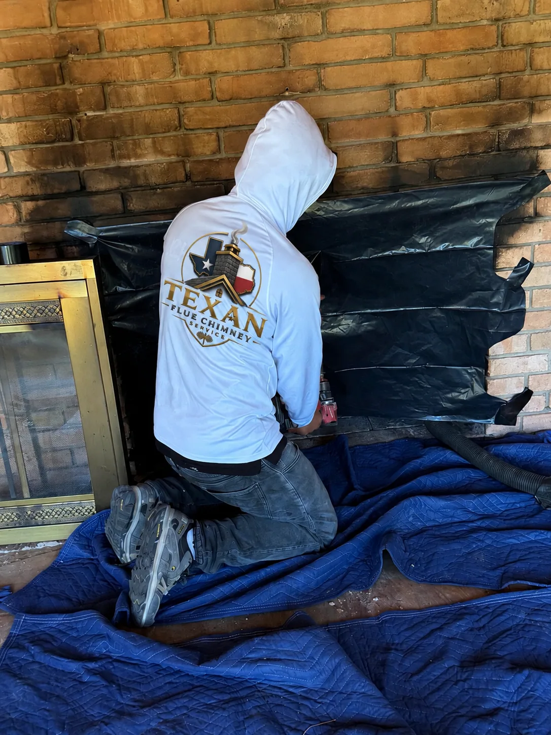 Texan Flue technician sealing a fireplace opening for HEPA-contained sweeping